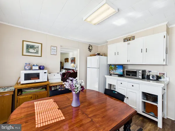 a kitchen with a table chairs stove and refrigerator