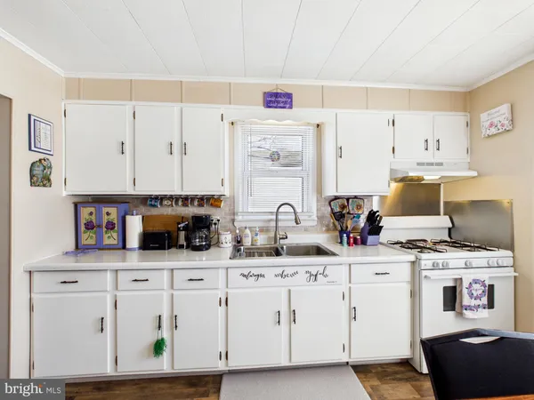 a kitchen with stainless steel appliances white cabinets and a sink