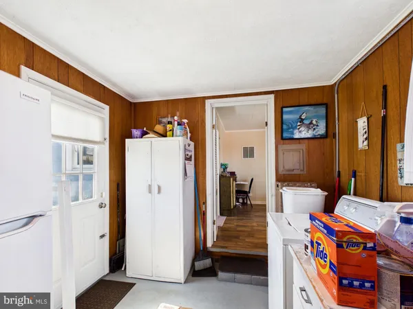 a view of an entryway with workspace and bedroom
