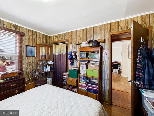 a bedroom with a bed closet and a large window