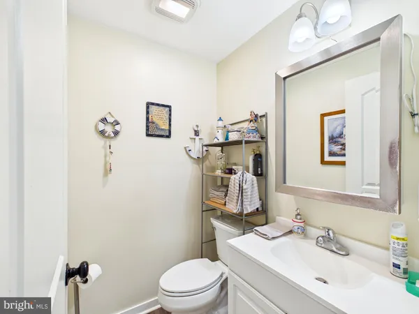 a bathroom with a toilet a sink and mirror