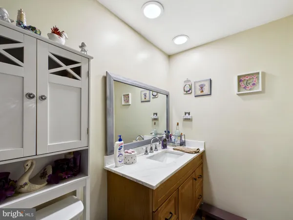 a bathroom with a sink vanity and a mirror