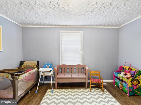 a bedroom with furniture and a wooden floor