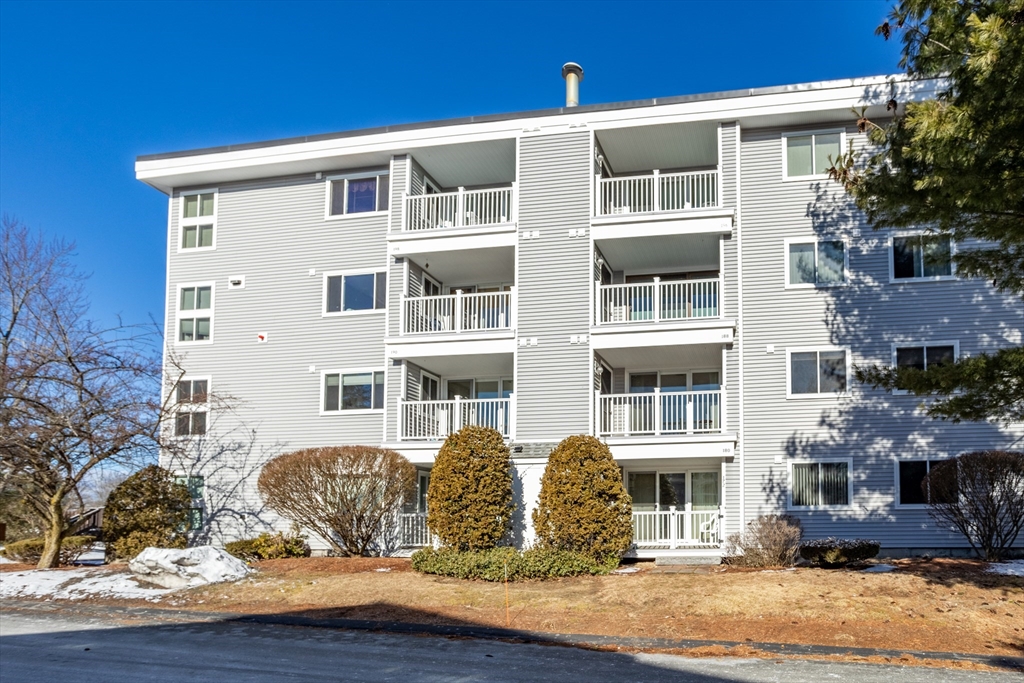 255 North Road, Unit 172 Chelmsford, MA 01824 - Photo 2 of 29 a front view of a house with a yard