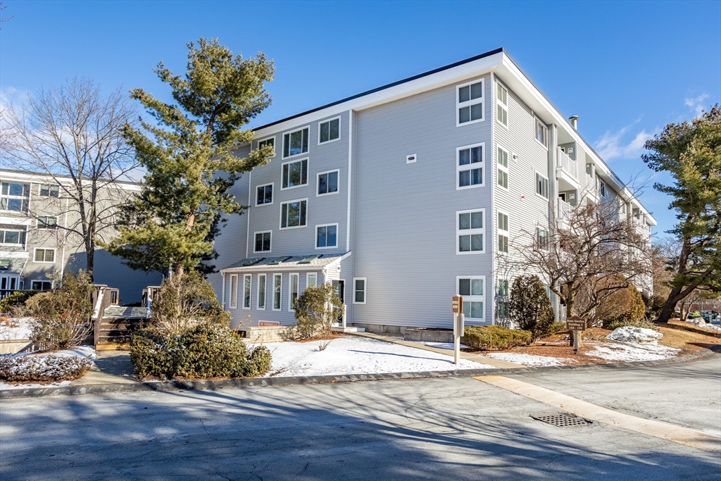 255 North Road, Unit 172 Chelmsford, MA 01824 - Photo 10 of 29 a front view of a building with a road