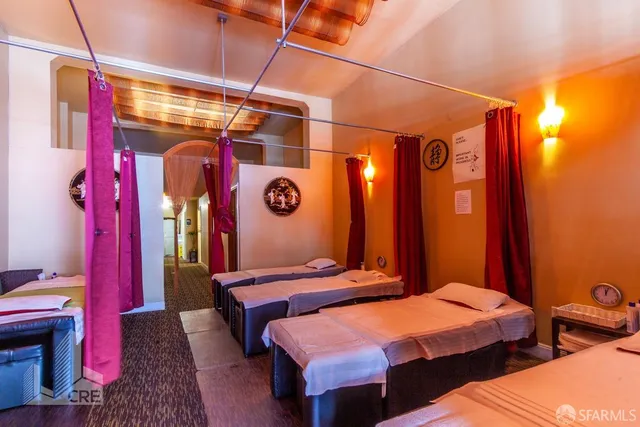 a bedroom with two beds and painted walls