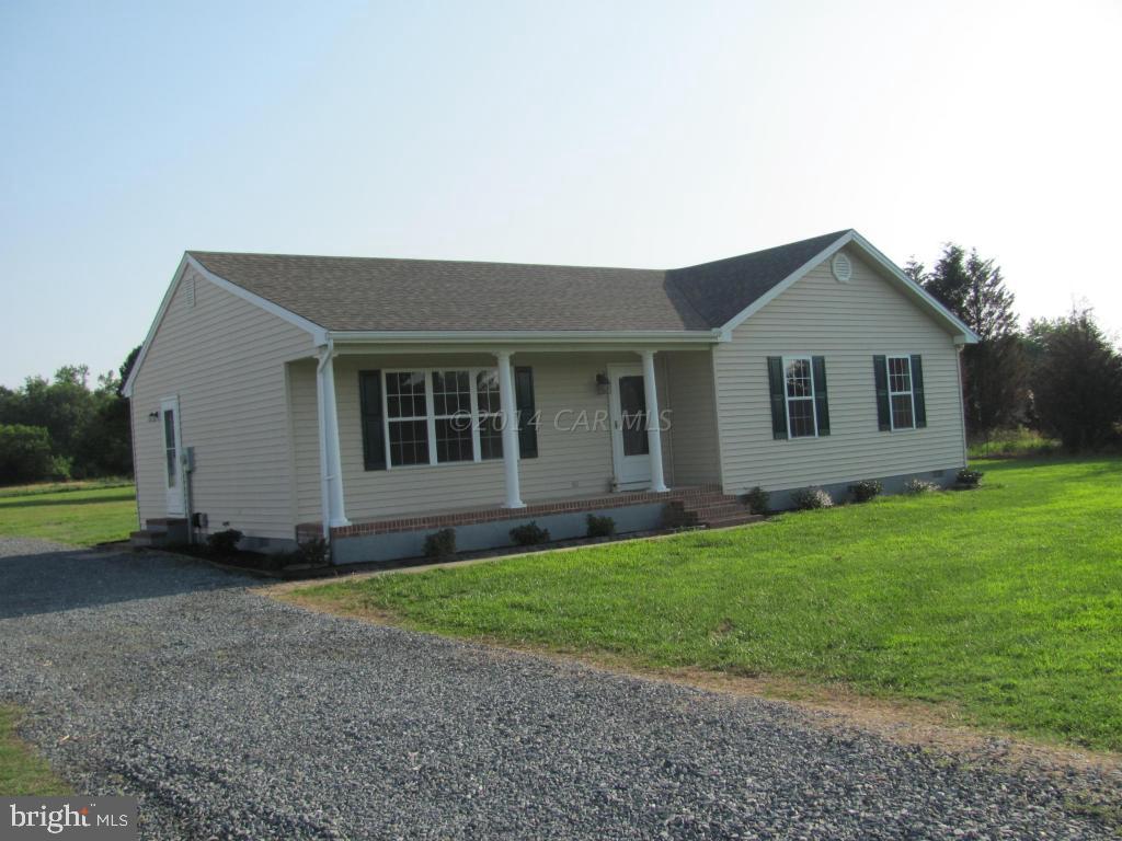 27105 Walnut Tree Road Salisbury, MD 21801 - Photo 3 of 21 a front view of a house with a garden and yard