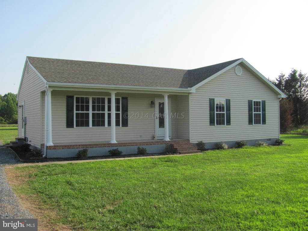 27105 Walnut Tree Road Salisbury, MD 21801 - Photo 4 of 21 a front view of a house with a yard and garage