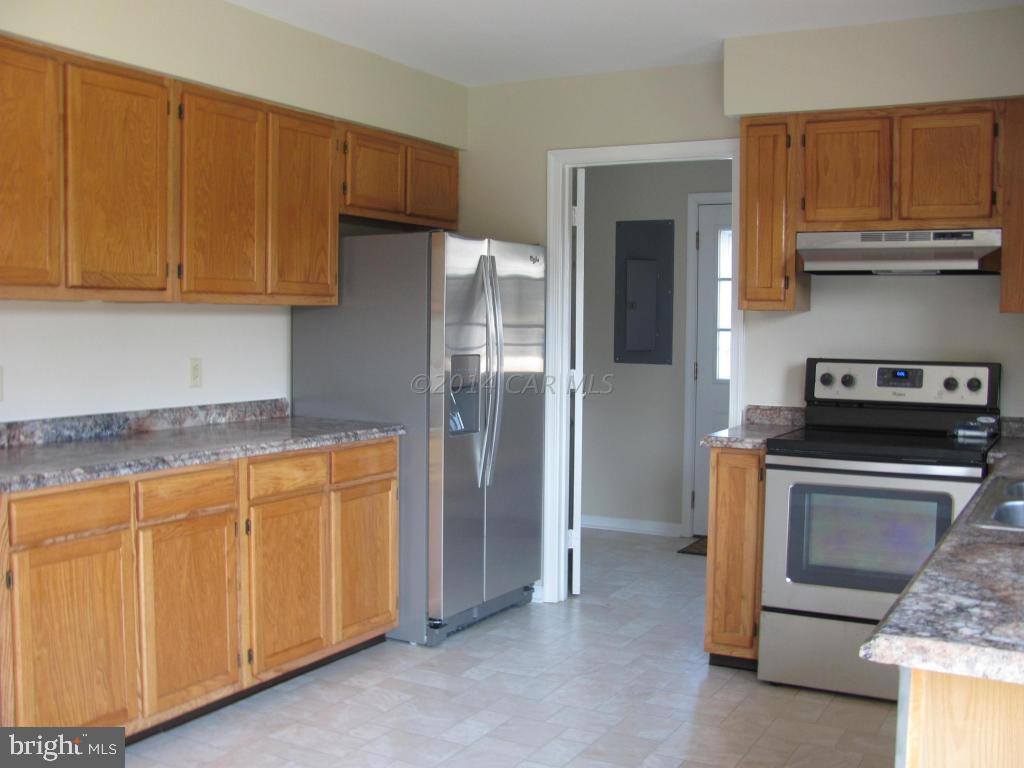 27105 Walnut Tree Road Salisbury, MD 21801 - Photo 8 of 21 a kitchen with stainless steel appliances granite countertop a refrigerator stove and cabinets