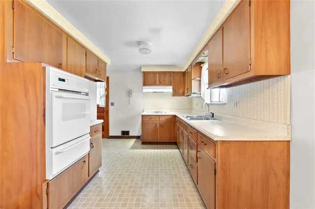 a kitchen with stainless steel appliances a refrigerator sink and cabinets