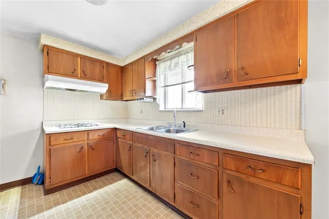 a kitchen with sink cabinets and window