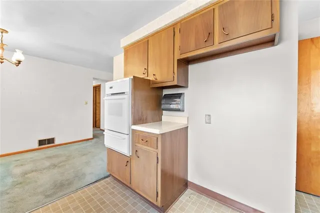 a utility room with cabinets washer and dryer
