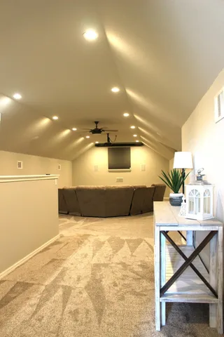 a view of a livingroom with furniture and a ceiling fan