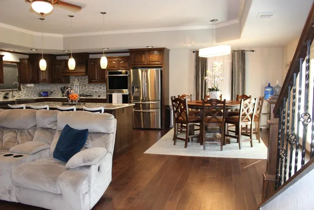 a living room with furniture wooden floor and a large window