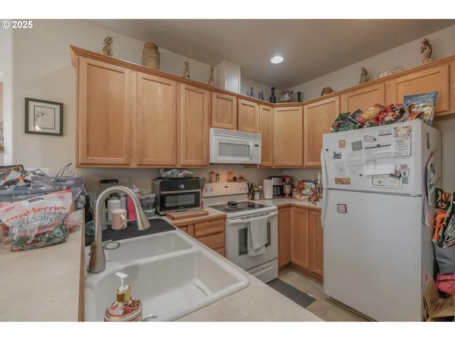 a kitchen view with living room furniture and a chandelier