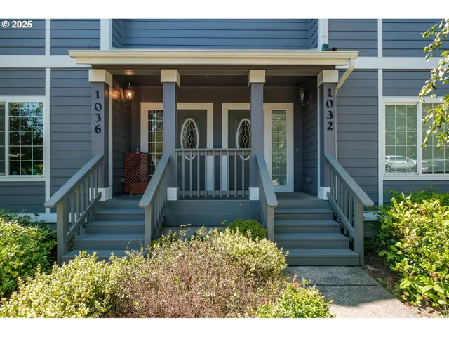 a view of a house with entryway and flower plants