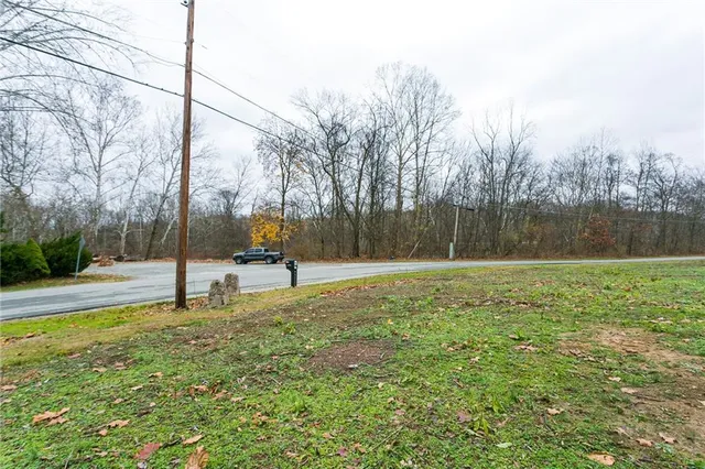 a house view with swimming pool in front of it