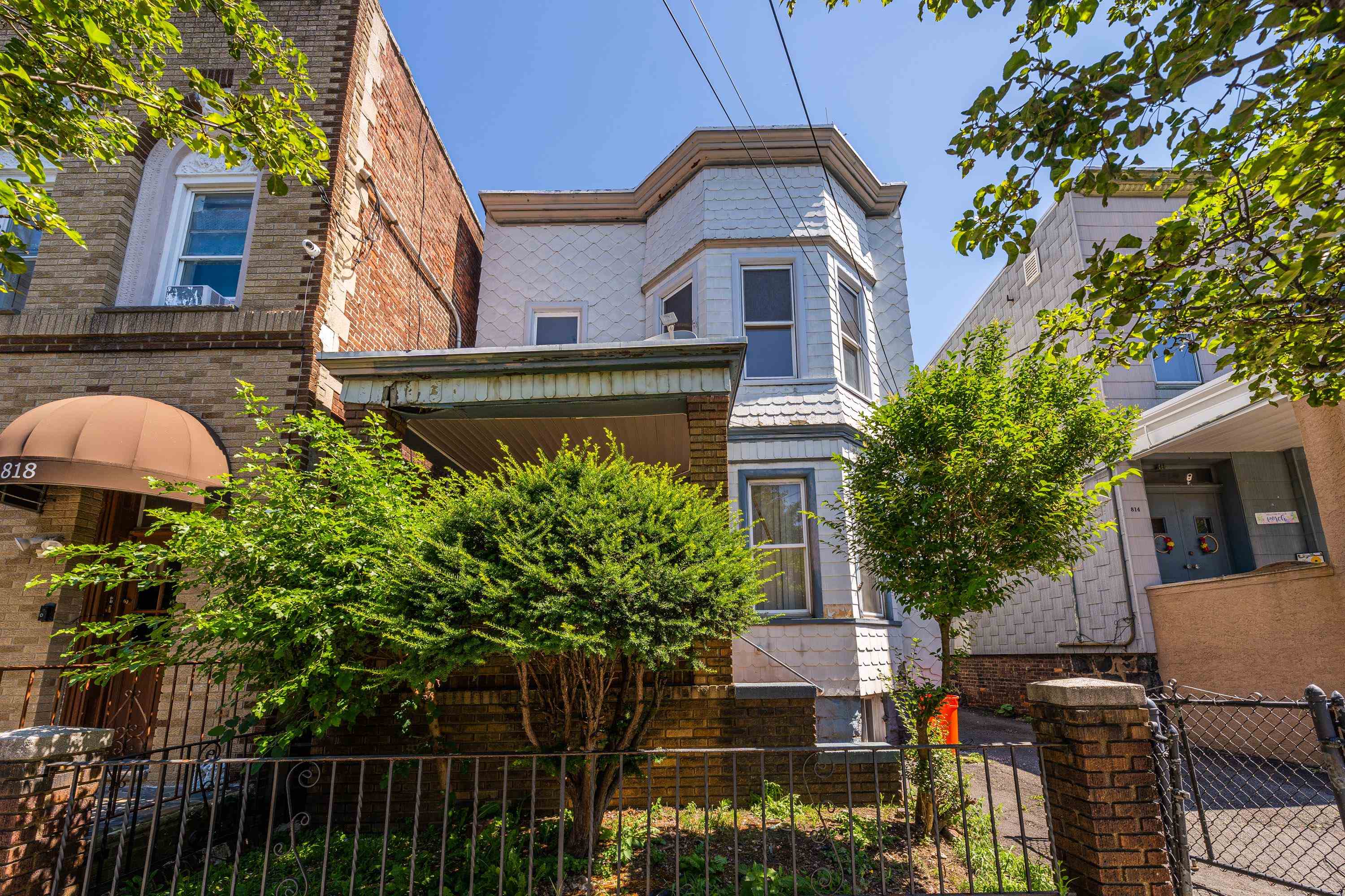 816 20th Street Union City, NJ 07087 - Photo 1 of 15 a view of a house with brick walls and potted plants