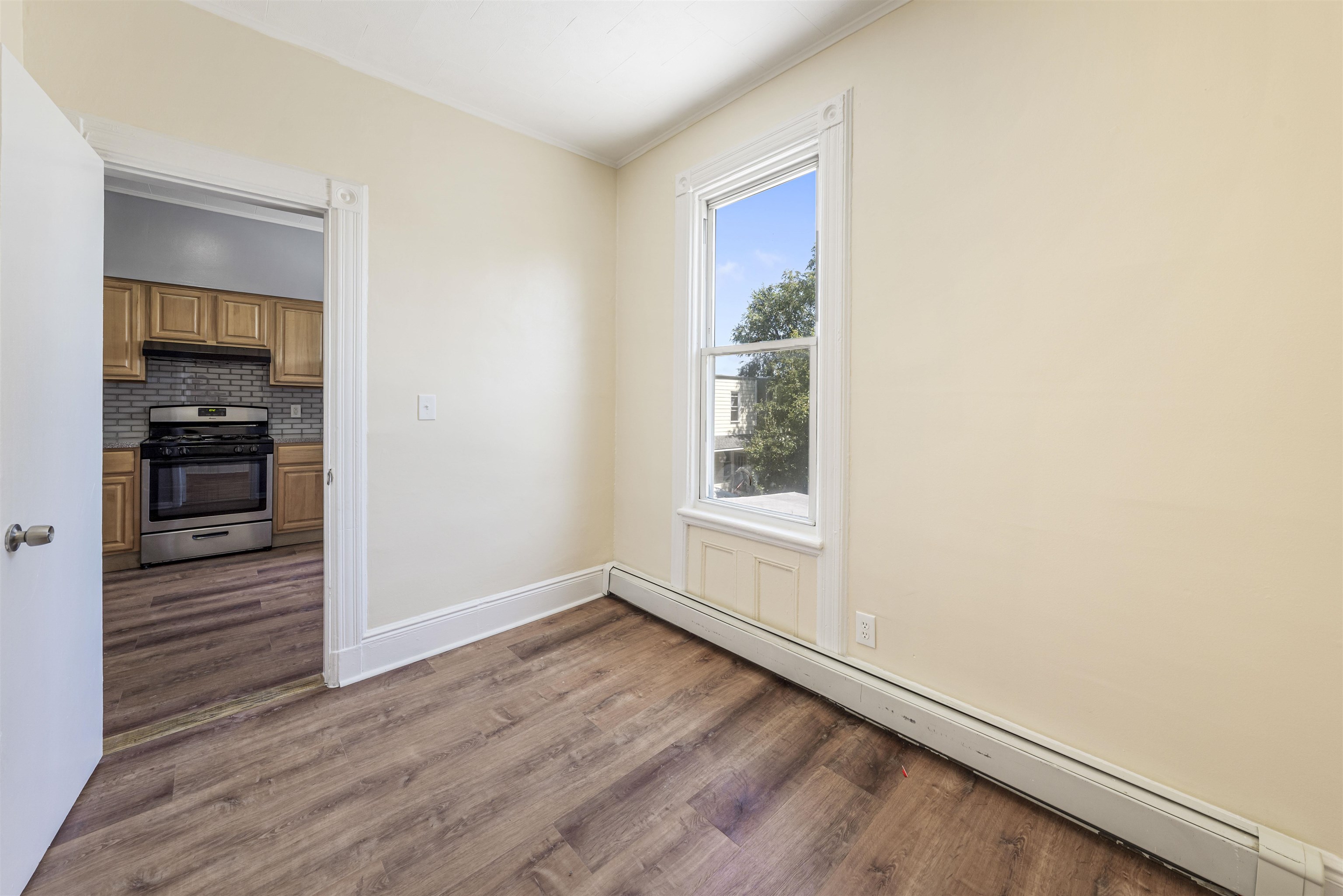 816 20th Street Union City, NJ 07087 - Photo 12 of 15 an empty room with wooden floor closet and windows