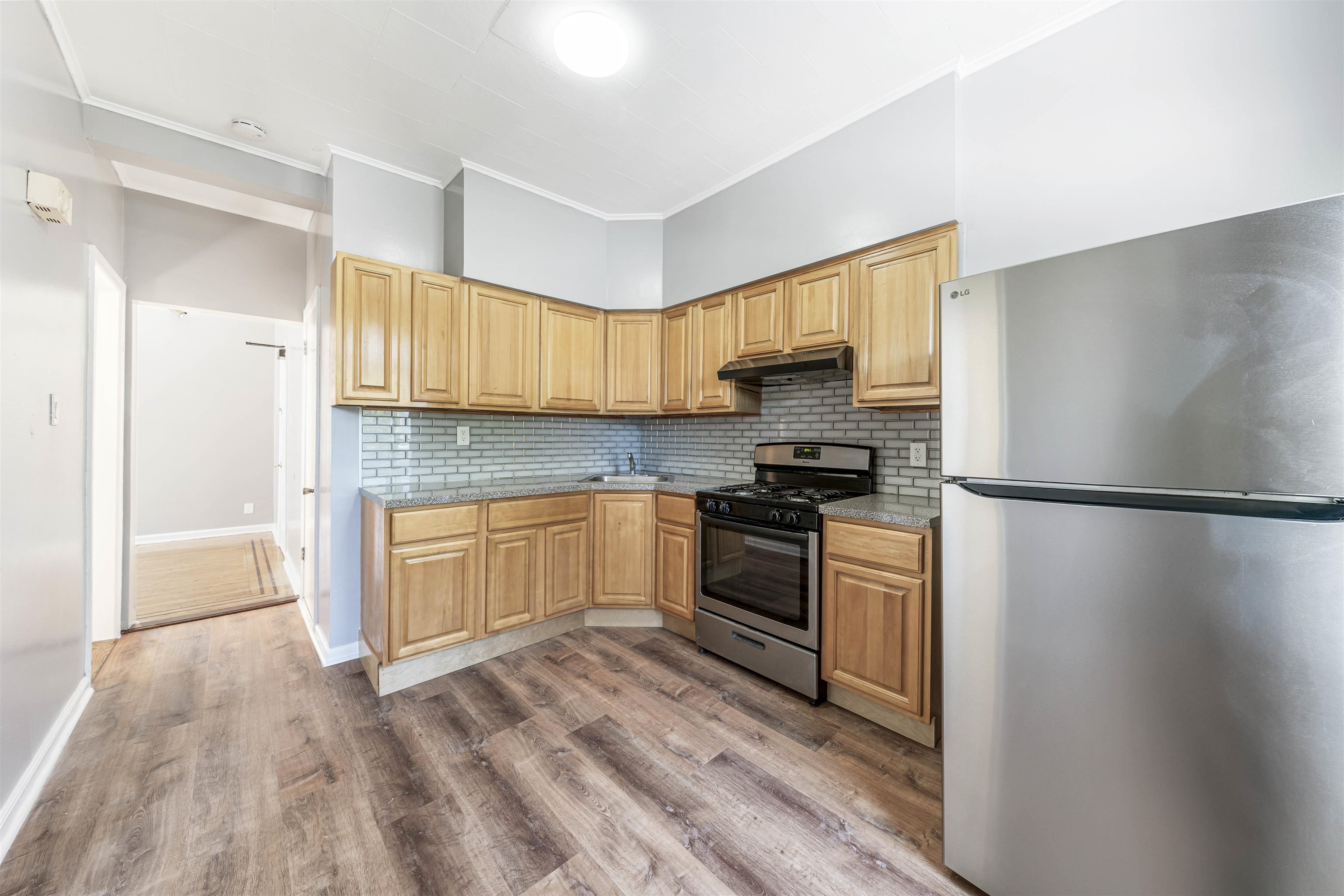 816 20th Street Union City, NJ 07087 - Photo 5 of 15 a kitchen with a refrigerator and a stove top oven