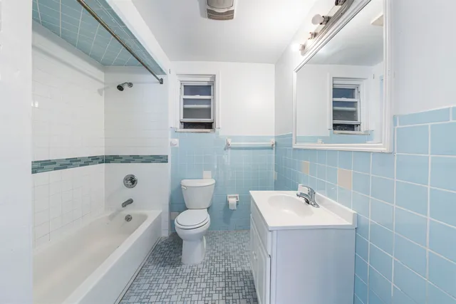 a bathroom with a sink a toilet and bathtub