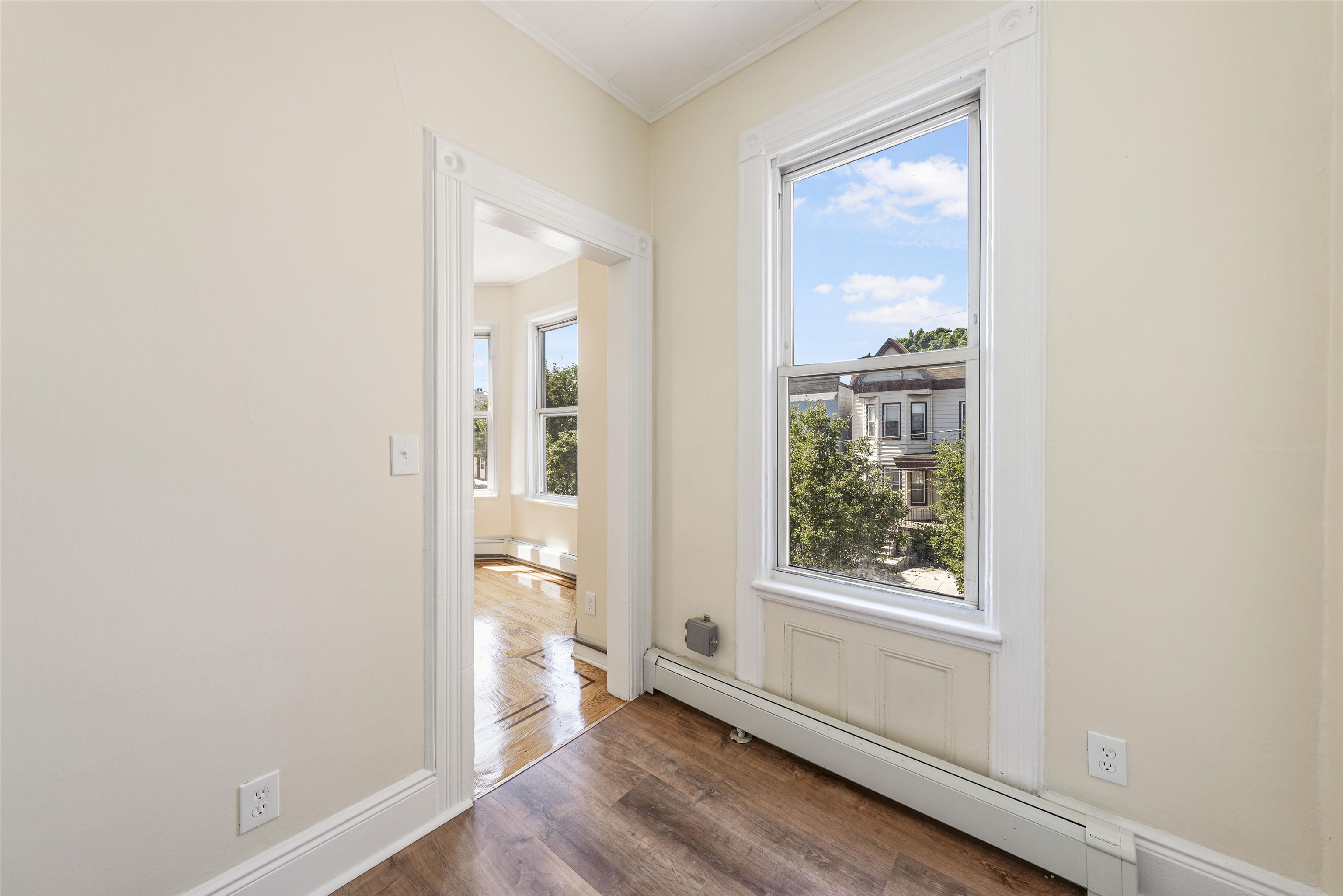 816 20th Street Union City, NJ 07087 - Photo 8 of 15 an empty room with wooden floor closet and windows