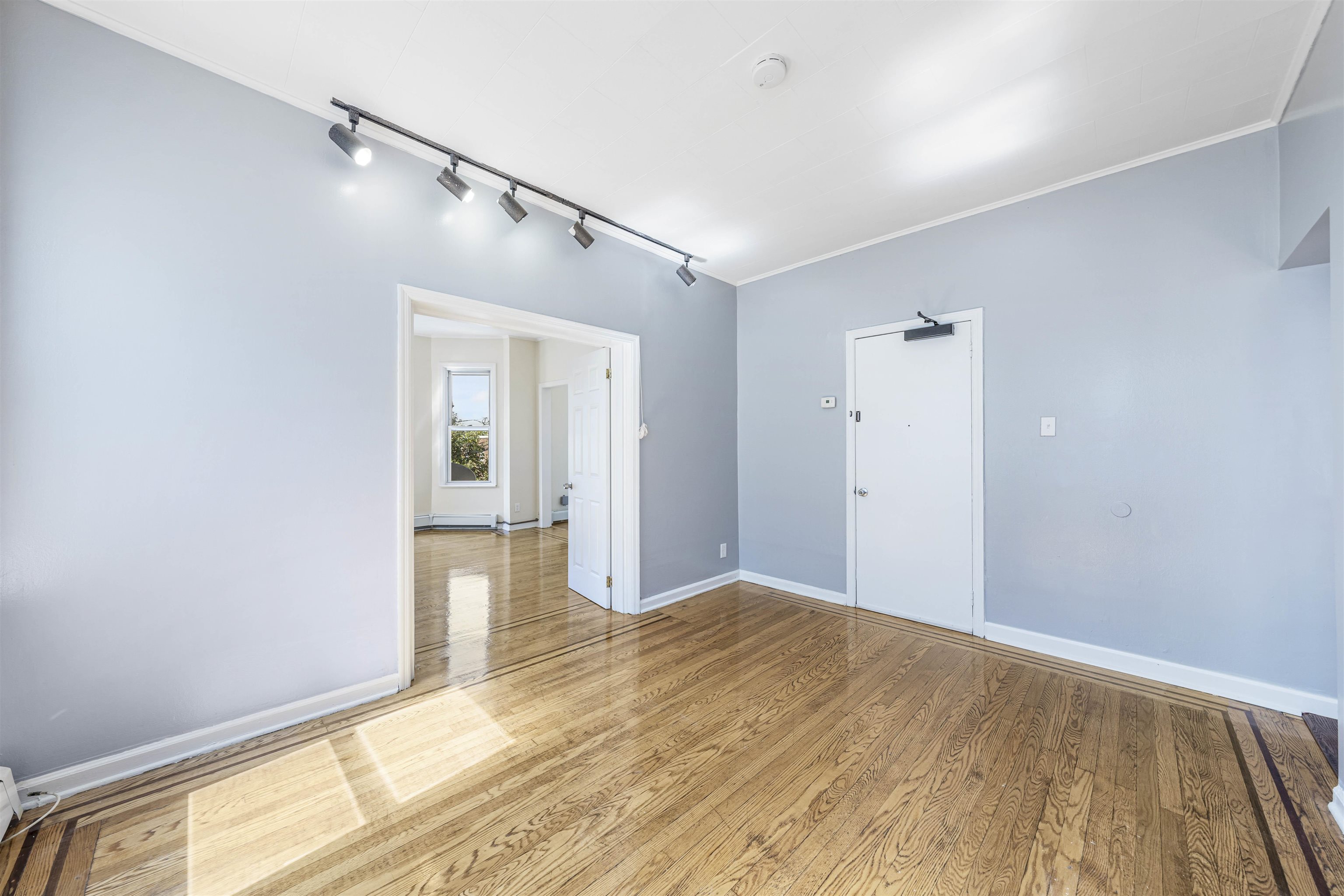 816 20th Street Union City, NJ 07087 - Photo 10 of 15 a view of a big room with wooden floor and windows
