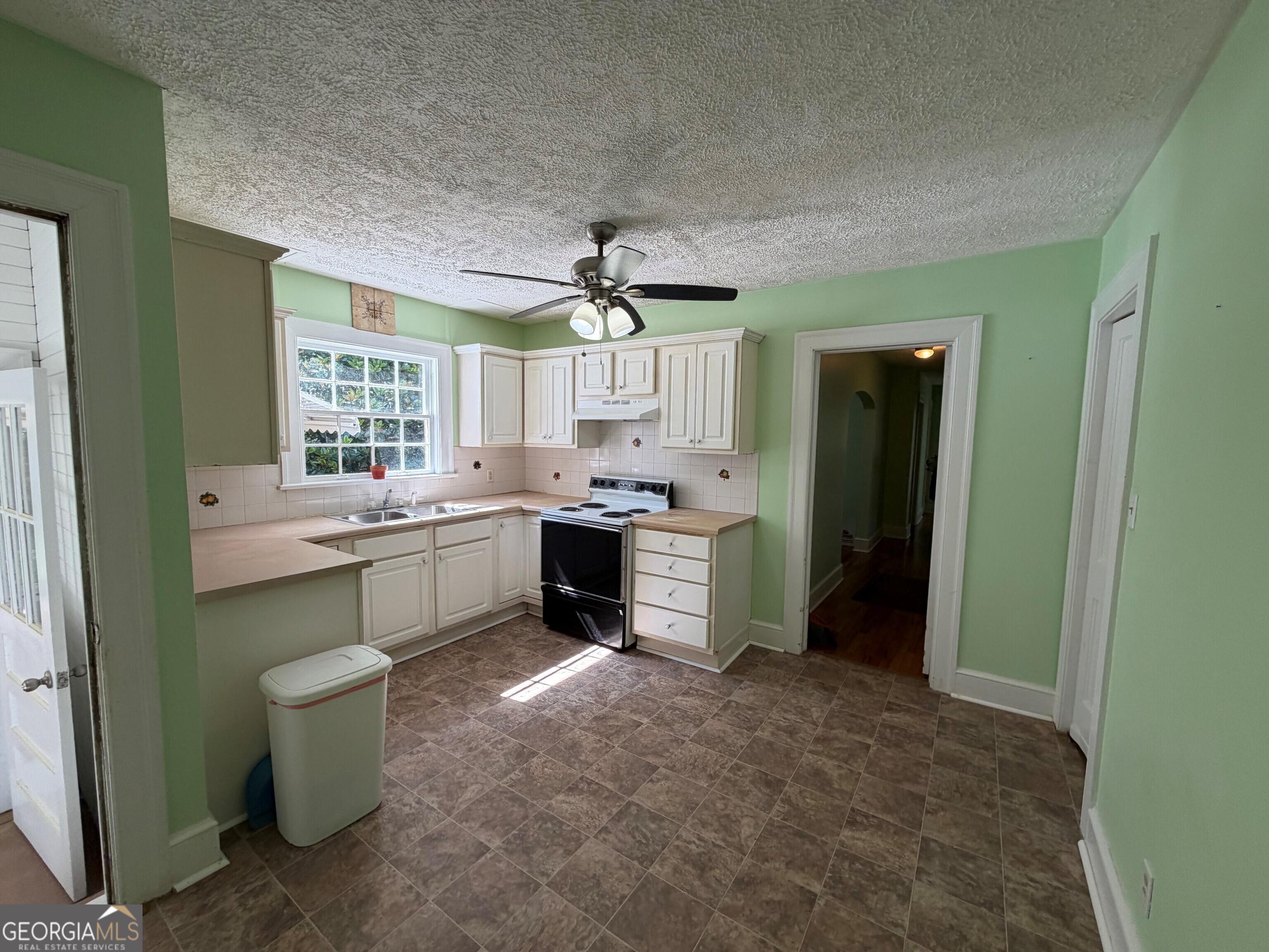 2619 Maple Road Southeast Rome, GA 30161 - Photo 7 of 31 a kitchen with a sink and a refrigerator