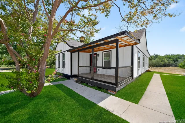 a view of house with backyard yard and deck