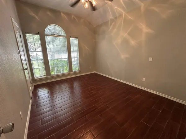 wooden floor in an empty room with a window