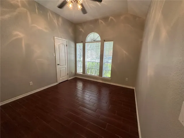 wooden floor in an empty room with a window