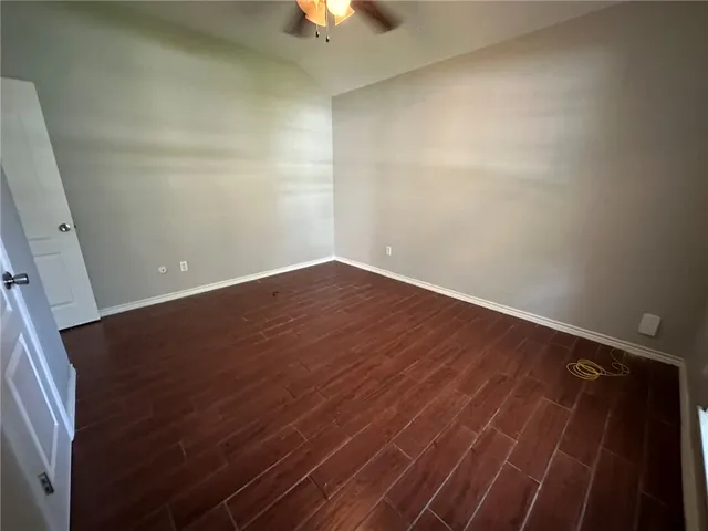 en empty room with wooden floor