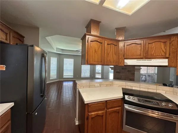 a kitchen with a refrigerator and a sink