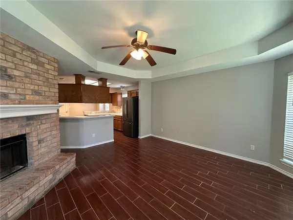 wooden floor in an empty room with a fireplace