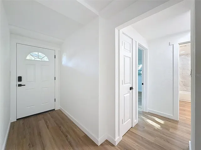 a view of a hallway with wooden floor