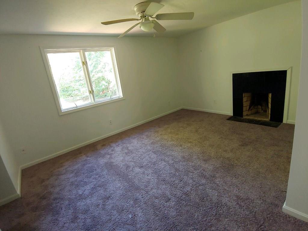 42 Bushy Lane Rutland, MA 01543 - Photo 20 of 31 an empty room with windows and fireplace