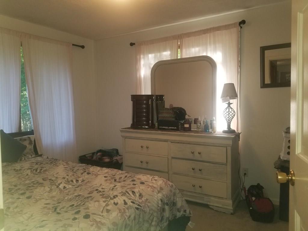 42 Bushy Lane Rutland, MA 01543 - Photo 28 of 31 a bedroom with a bed and a mirror on dresser