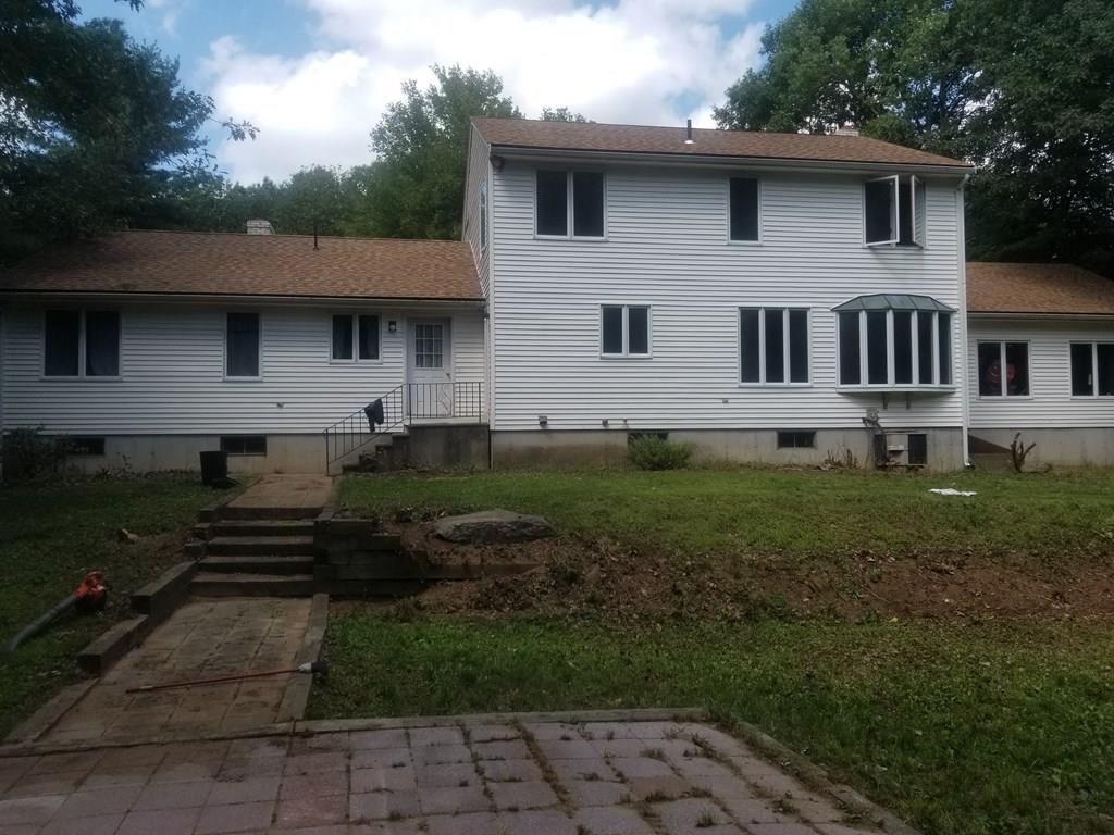 42 Bushy Lane Rutland, MA 01543 - Photo 3 of 31 a front view of a house with a yard