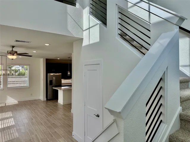 a view of a hallway view with wooden floor and staircase