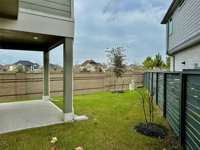 a backyard of a house with two chairs and a table