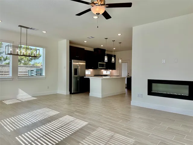 a view of kitchen with granite countertop cabinets and window