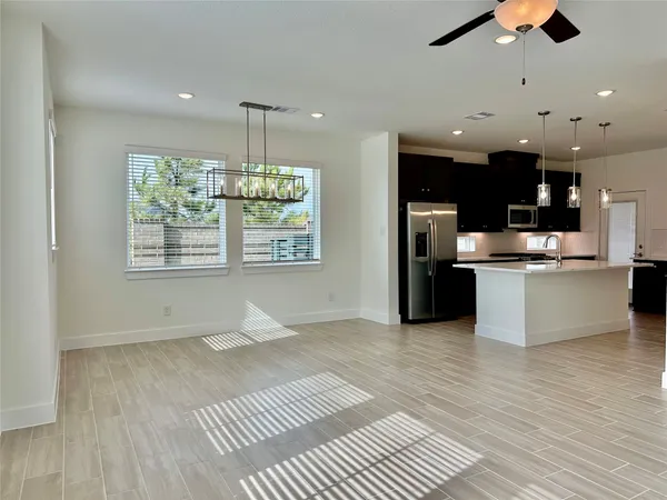 a open kitchen with stainless steel appliances granite countertop a stove and a refrigerator