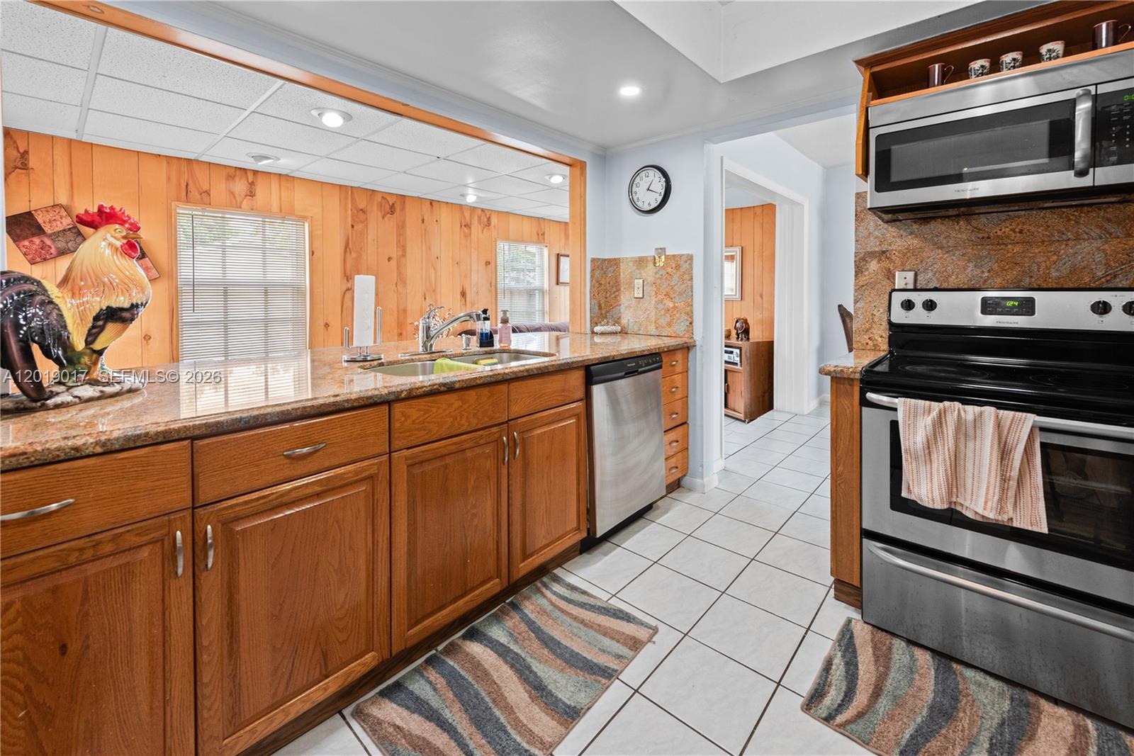 731 Northwest 17th Street Homestead, FL 33030 - Photo 5 of 29 a kitchen with stainless steel appliances a stove sink and cabinets