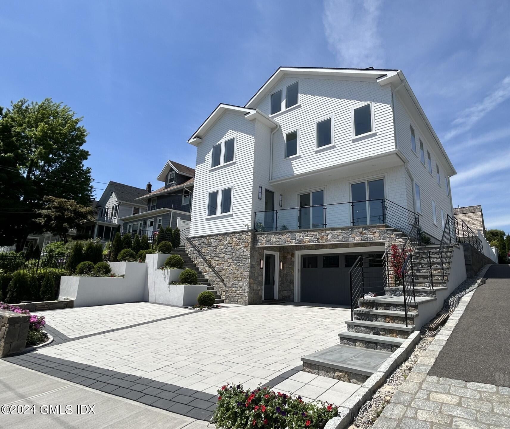 151 East Elm Street Greenwich, CT 06830 - Photo 1 of 29 a front view of a house with a yard