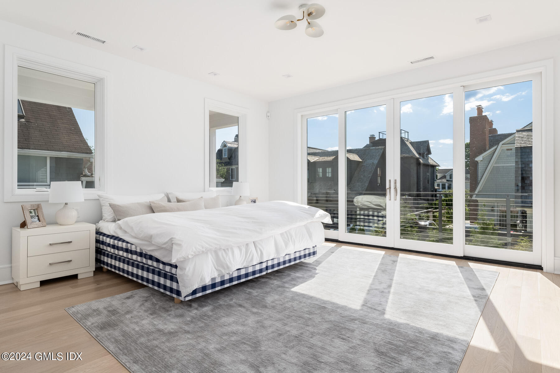 151 East Elm Street Greenwich, CT 06830 - Photo 12 of 29 a spacious bedroom with a bed and a large window