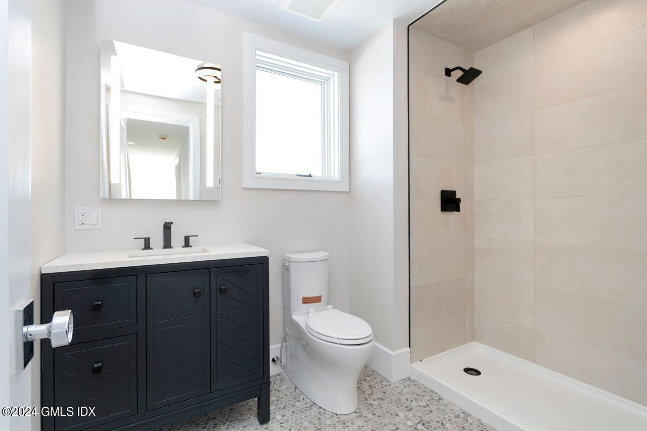 151 East Elm Street Greenwich, CT 06830 - Photo 16 of 29 a bathroom with a sink a toilet and shower