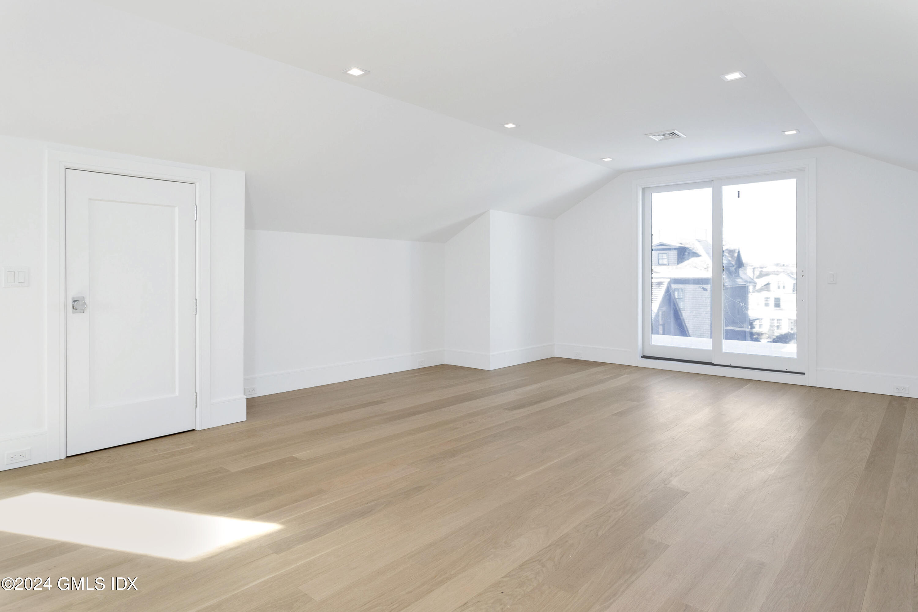 151 East Elm Street Greenwich, CT 06830 - Photo 17 of 29 an empty room with wooden floor and windows