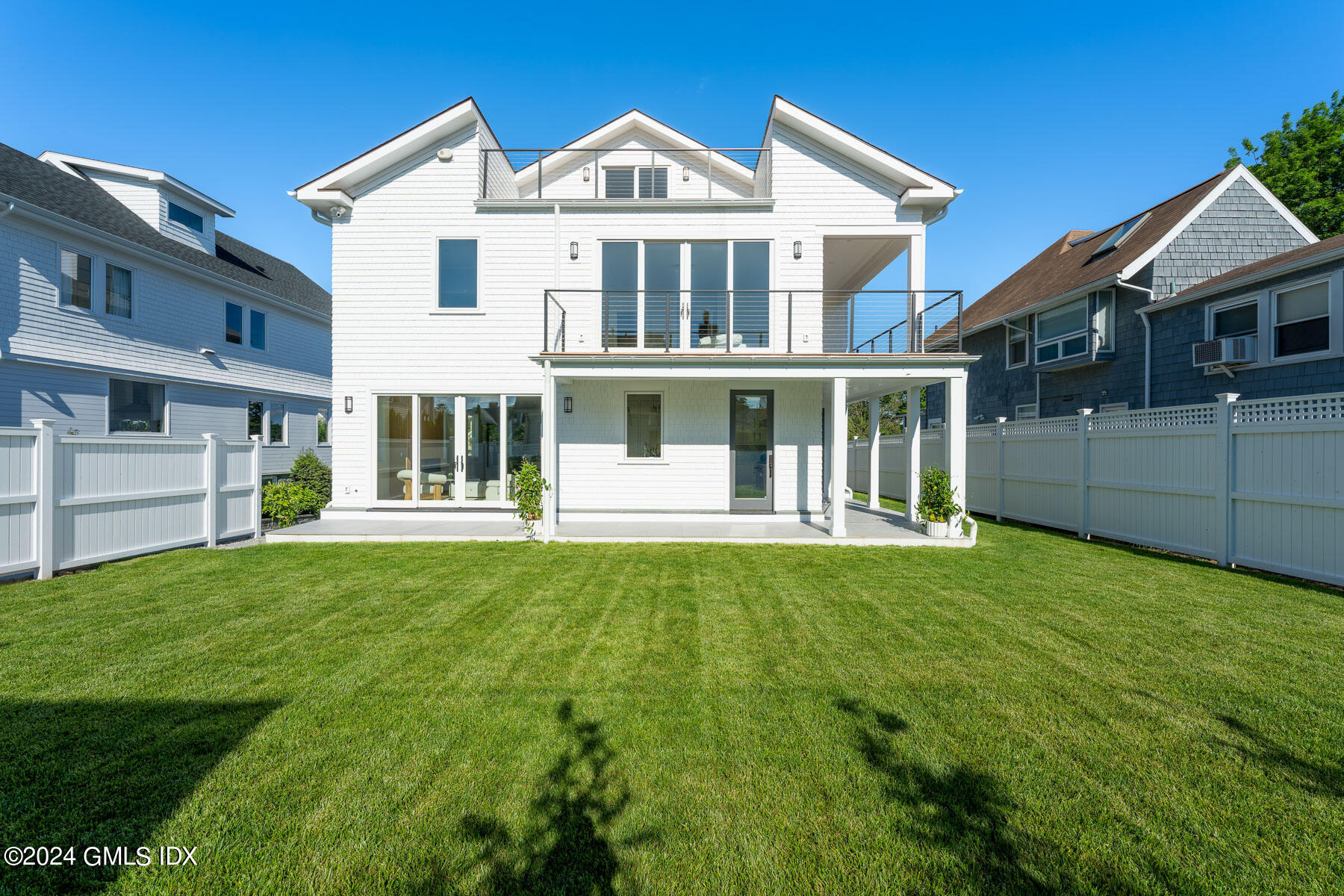 151 East Elm Street Greenwich, CT 06830 - Photo 23 of 29 a front view of a house with a garden