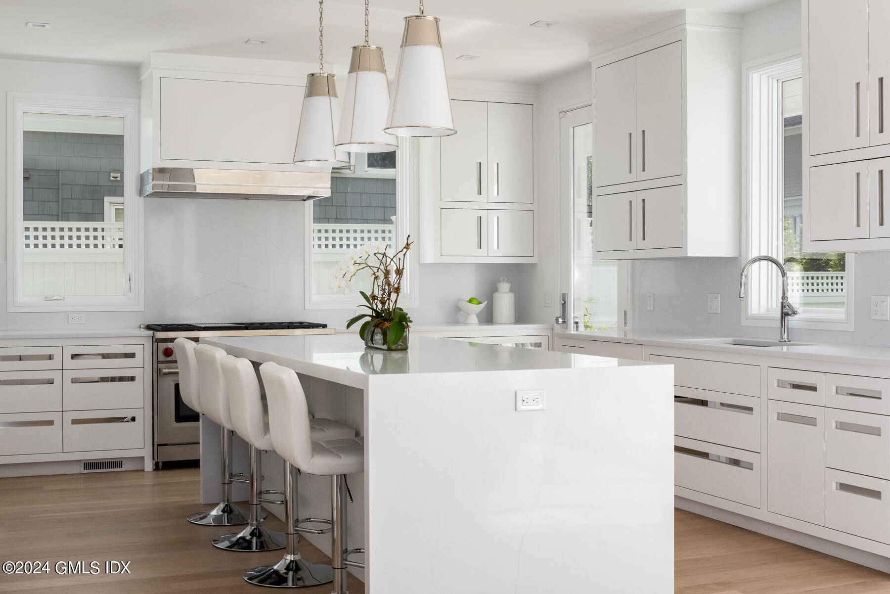151 East Elm Street Greenwich, CT 06830 - Photo 6 of 29 a kitchen with white cabinets and appliances