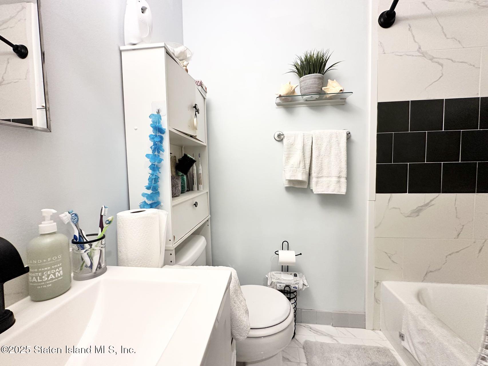 453 Ilyssa Way Staten Island, NY 10312 - Photo 12 of 16 a bathroom with a sink toilet and shower